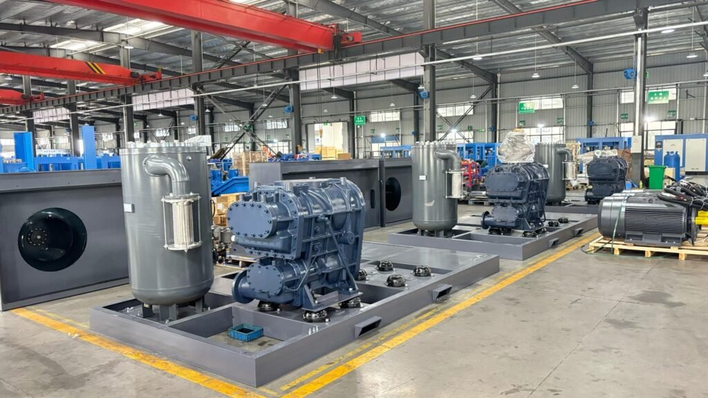 Large two-stage compressor airends and oil separator vessels installed on equipment base frames