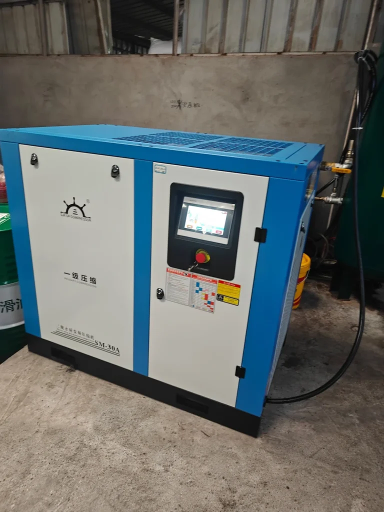 SM-30A compressor at a customer site with connected pipework and original equipment branding.